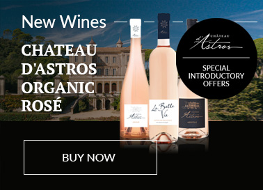 Three bottles of varying Chateau d'Astros Organic Provence Rosé in front of the Chateau d'Astros.