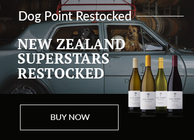 A selection of Dog Point Wines displayed on a reflective black surface in front of an image of a light blue vintage car full of dogs with boxes of wine strapped to the roof-rack.